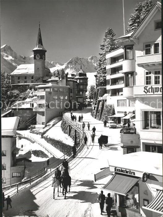 11631118 Arosa GR Strassenpartie mit Kirche und Hotel Schweizerhof